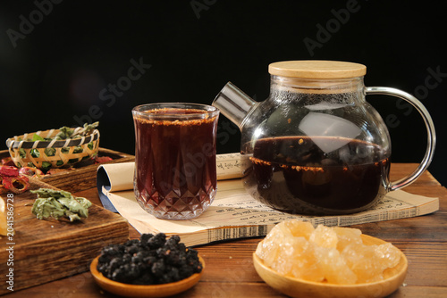 Obraz na plátně Traditional Chinese Herbal Tea with Osmanthus Plum Hawthorn and Chenpi on Wooden