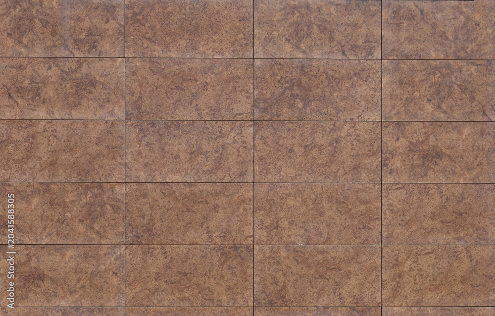 Fototapeta premium Brown porcelain stoneware tiles for flooring or wall coating with stone and earthenware effect. Full frame, background and texture.