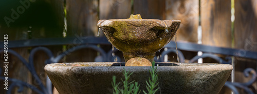 Tiered stone water fountain trickling in a garden