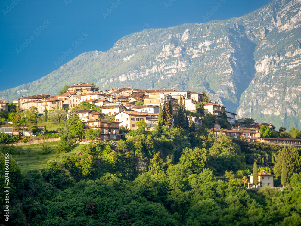 Obraz premium View of the village of Voltino. In the background are Monte Baldo and an indigo-colored sky. Voltino is part of the municipality of Tremosine.