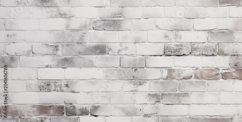 Weathered white brick wall texture with rustic charm and soft grey shadows for backdrop