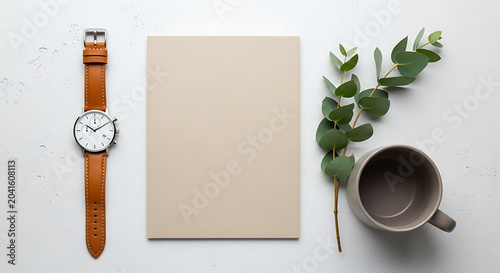Blank paper sheet with wristwatch and eucalyptus flat lay