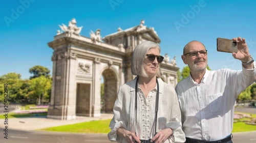 Senior Couple Tourists Taking Selfie at Historic City Arch Monument on Sunny Day