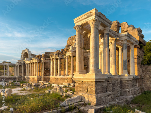 Monumental fountain ruins at Side Ancient City under dramatic blue sky in Antalya, Turkey