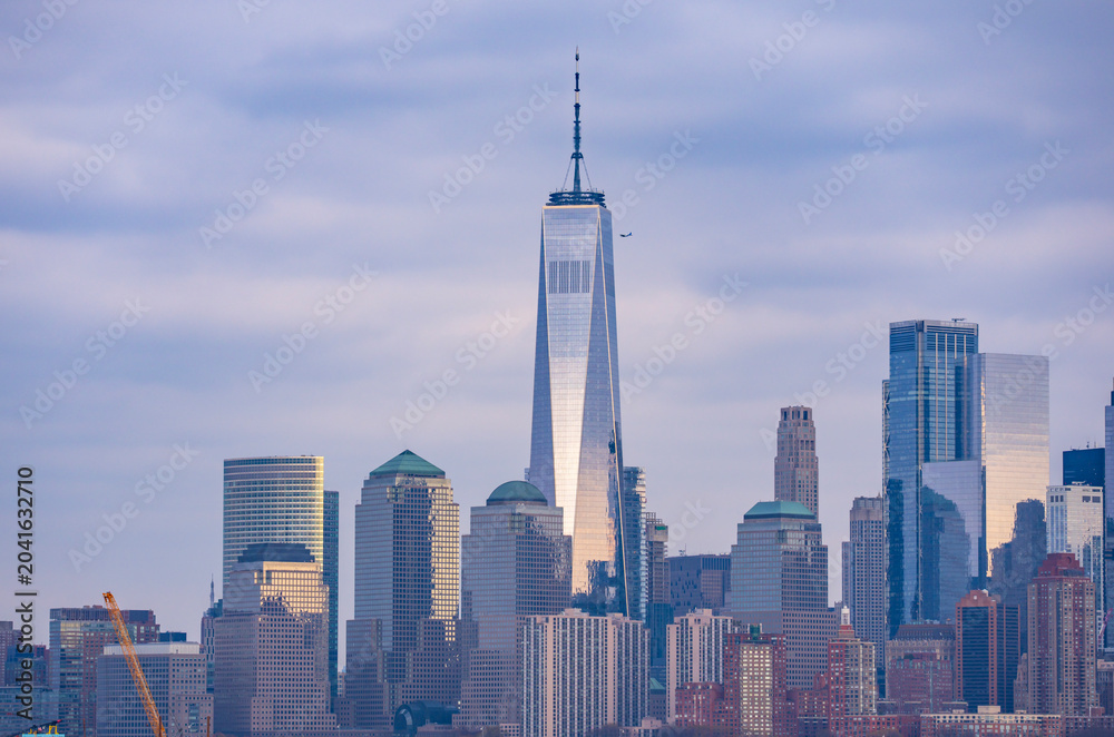 Fototapeta premium Manhattan skyscrapers with blue tones in New York NYC. Manhattan cityscape photography in New York NYC. Manhattan panorama with urban towers in New York NYC.