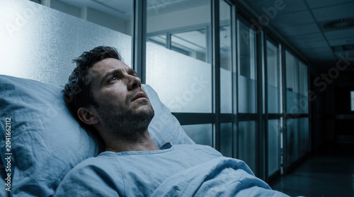 Patient Laying In Hospital Bed Is Contemplating and Looks Towards The Light