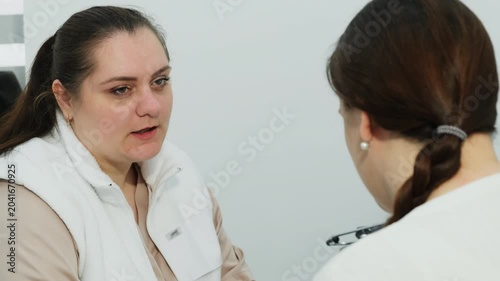 Woman doctor listens to patient complaining in hospital slow motion. Attentive female physician conducts appointment in medical office