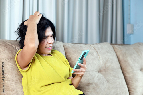 Stressed woman looking smartphone, financial problems, bad news, debt daily life, social media stress, emotional breakdown, anxiety, frustration, mental pressure, intense expression
