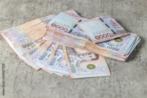 Stack of Thai 1,000 baht banknotes, concept of finance, money, cash, wealth, savings, investment, income and business success