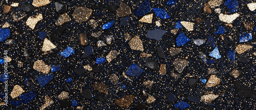 Sparkling black texture embedded with vibrant blue and shimmering gold irregular fragments, resembling a glitter terrazzo design