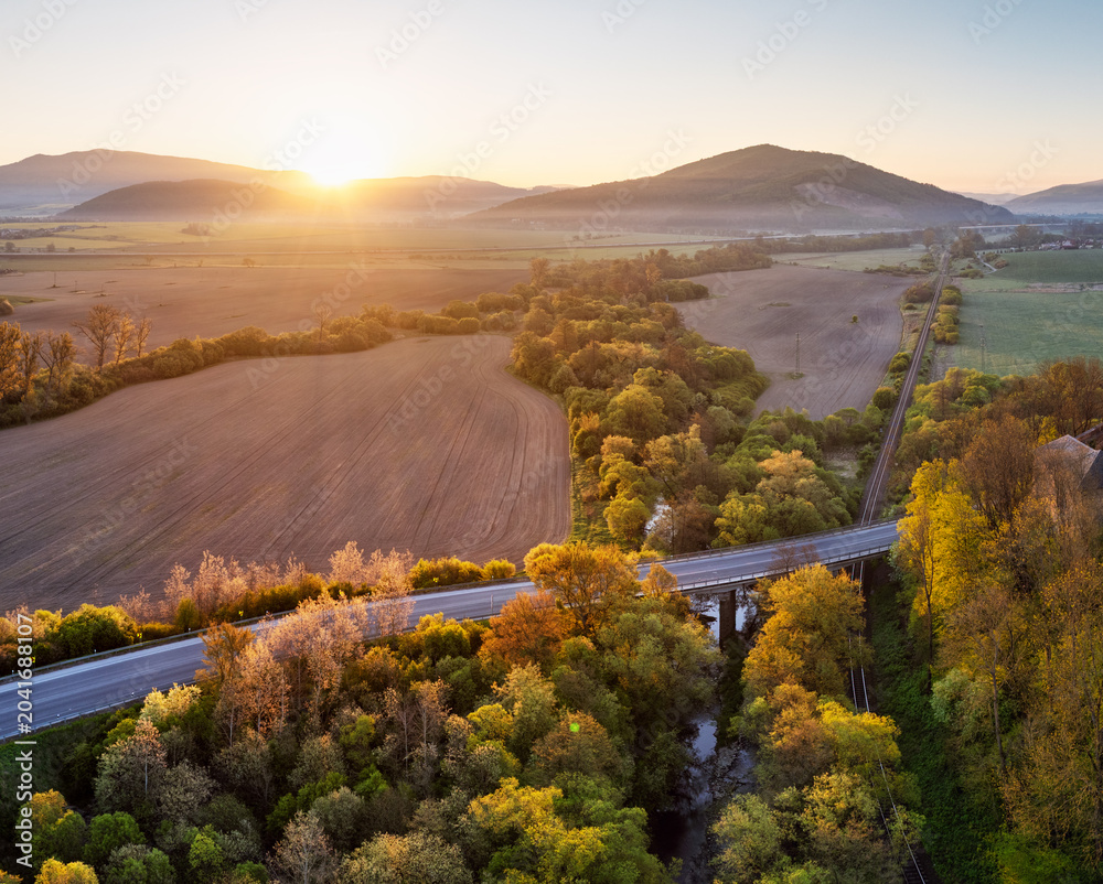 Fototapeta premium Sunrise in Slovakian countryside with forest
