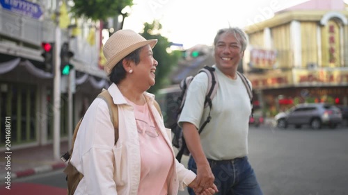 Asian senior couple traveler traveling and exploring the city outdoors. 