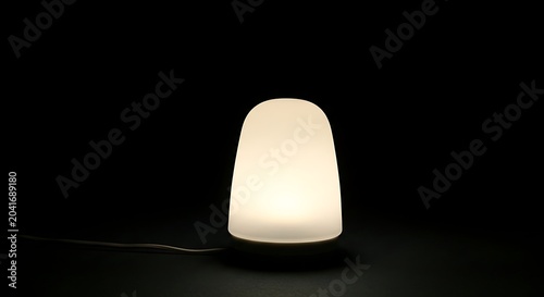 Warm Glowing Table Lamp Illuminated on Dark Minimal Background