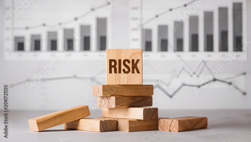 Risk Concept with Wooden Blocks on a Financial Chart Background