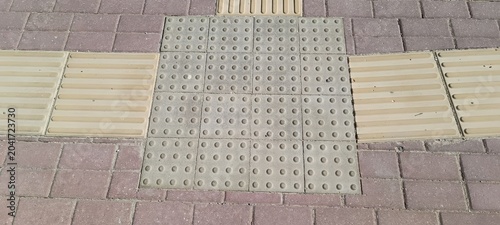 Bild auf Leinwand close up of tactile paving with raised dots bars on sidewalk for visually impaired pedestrians