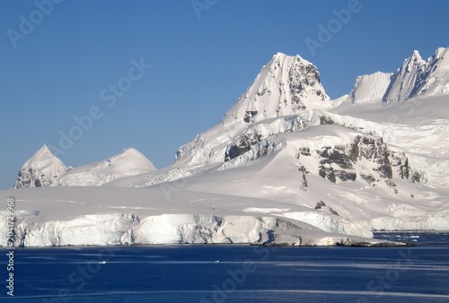 spectacular Antarctica  mountain peaks and ice floes  on a sunny summer day in the neumayer channel in the palmer archipelago in  northern antarctica