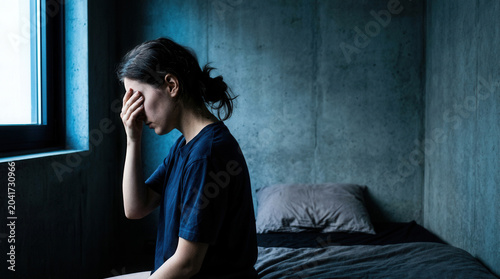 Woman Suffering From Anxiety and Worry In a Dark Room, Emotional Pain, Concept Photo