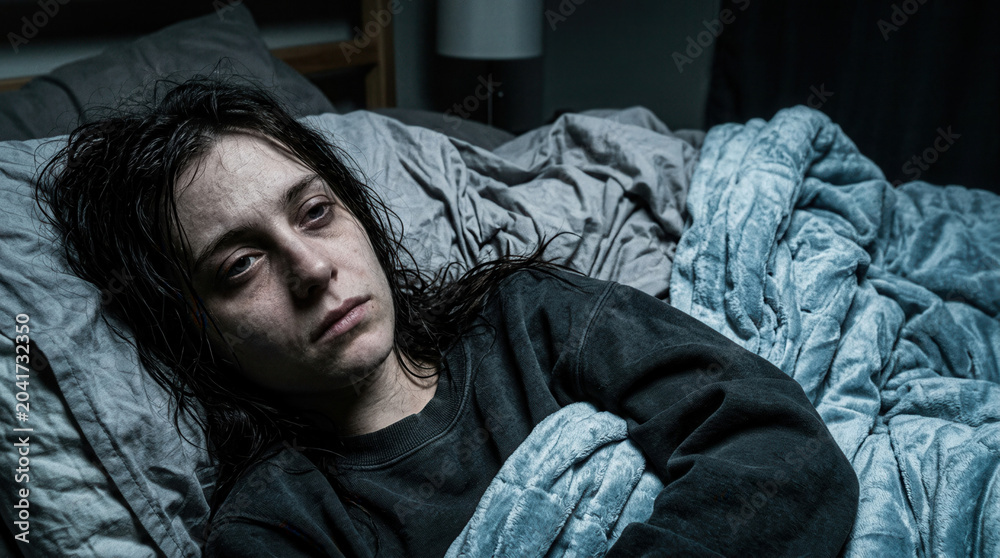 Fototapeta premium Woman Suffering From Exhaustion Lying in Bed, Facing the Reality of Sleeplessness