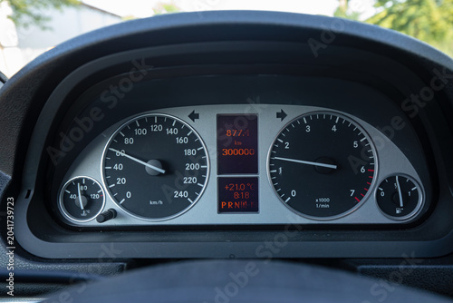 Close-up of a Mercedes-Benz B-Class car dashboard showing a milestone of 300,000 kilometers driven. Modern vehicle instrument cluster with speedometer, tachometer, and digital display.