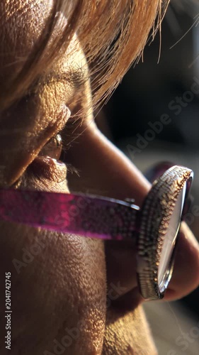 Eye opening. Close-up of a woman's face and eyes wearing glasses. in the sunset light from the window. Copy space. place for text