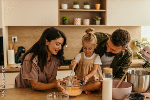 Принти на полотні Happy family baking together in modern kitchen