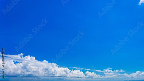 The blue sky and clouds are in widescreen aspect ratio as the background.