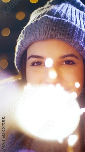 Young woman with a sparkler enjoying time for Christmas