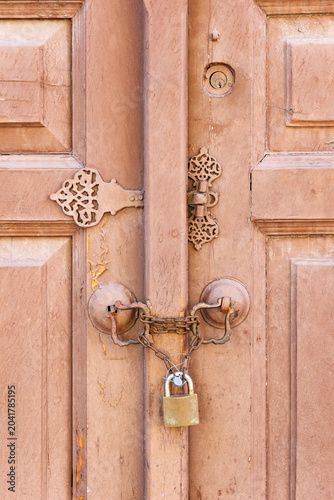 Old wooden door with decorative lock front view