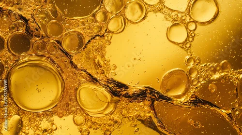 Fototapeta na wymiar Golden oil droplets and bubbles floating in a shallow liquid pool captured in vivid macro detail with rich amber tones for a culinary cooking background