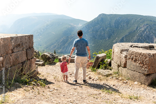 Father and Toddler Exploring Ancient Ruins in Delphi Greece