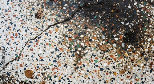 Cracked Multicolor Terrazzo Surface with Dark Stain in Urban Floor Detail