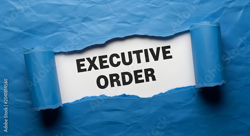 Torn blue paper reveals white sheet with black text Executive Order image