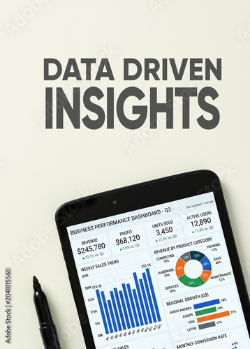 Data driven insights text with business performance dashboard on tablet screen