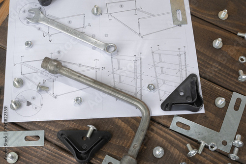 Metal shelving assembly process with bolts, nuts, brackets, tools and instruction manual. Suitable for furniture installation, home improvement and storage organization themes.