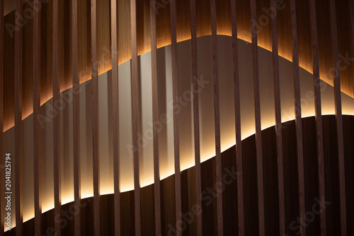 Wooden structure with soft lighting creates a modern design element in an indoor space
