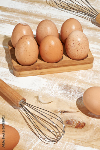 Obraz na plátně Natural Brown Eggs in Rustic Bamboo Wooden Egg Holder for Home Baking Breakfast