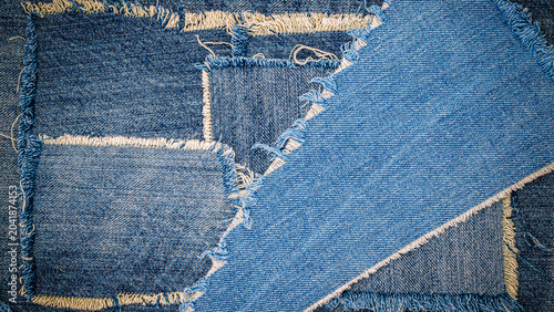 Картината върху платно Denim patches laid out for crafting projects with various shades of blue and fra