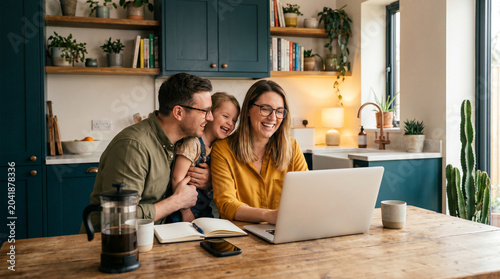 woman using laptop in modern kitchen, work from home lifestyle, parenting, remote work balance, happy family bonding, cozy home interior, digital living, everyday happiness daughter father with mother