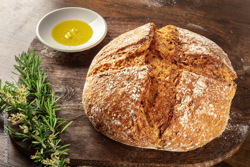 Homemade artisan sourdough bread loaf on a rustic wooden cutting board