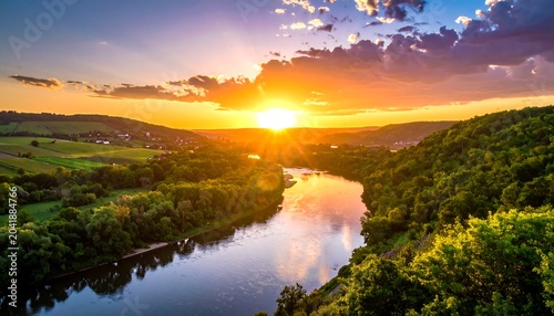 Golden Sunset Over Winding River Between Lush Green Hills in Rural Valley