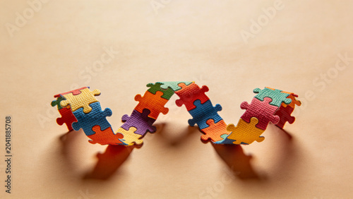Colorful puzzle pieces arranged in a wavy design on beige background  