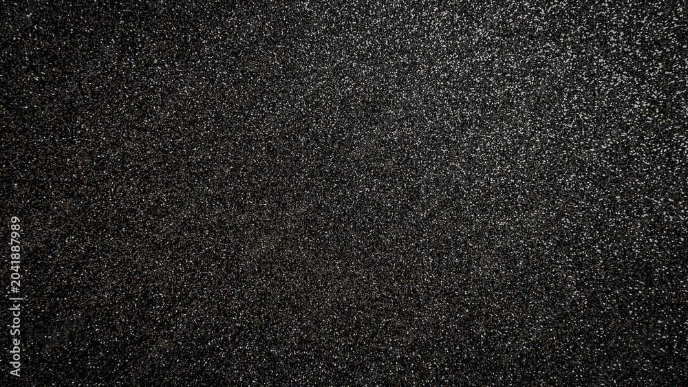 Fototapeta premium Black textured surface showing many small sparkles in a uniform pattern across the whole area