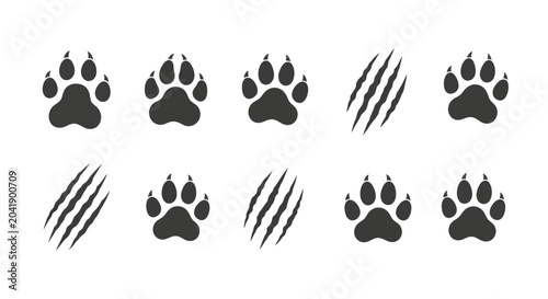 Tableau sur toile Collection of animal paw prints and claw marks in black on a white background