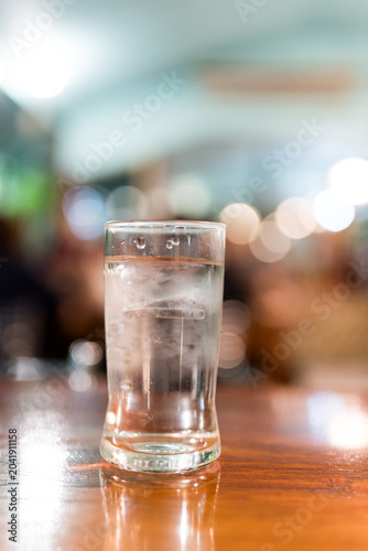 Water glass full of ice
