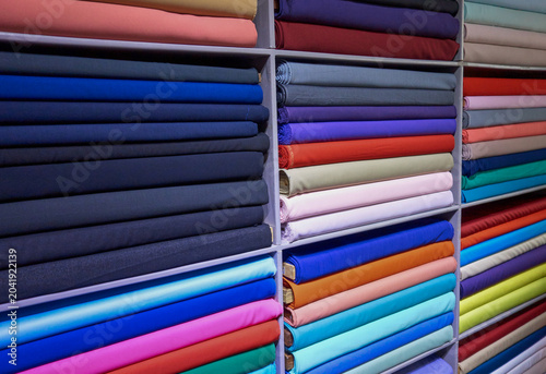фотографія Colorful Fabric Rolls Displayed in Tailor Shop, Da Nang, Vietnam
