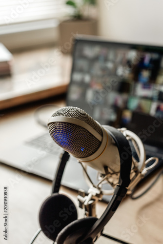 Microphone on the air and headphones for video conference calling on laptop computer