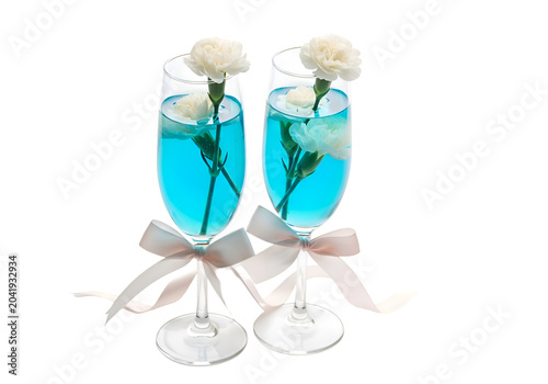 Two elegant cocktail glasses with blue liquid and white flowers on decorative stand on white background , Isolated on Transparent Background, PNG, Generative AI