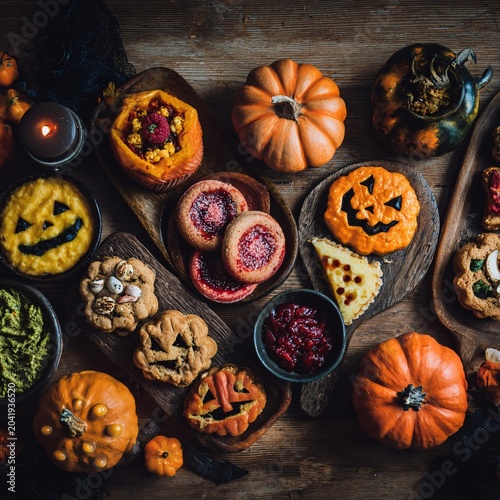 A variety of Halloween-themed foods arranged on wooden platters