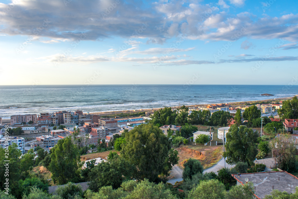 Fototapeta premium Small village with morning in state of Jijel, Algeria, rural village, A beautiful Mediterranean village in North Africa, Algeria from above, A small town overlooking the Mediterranean sea.