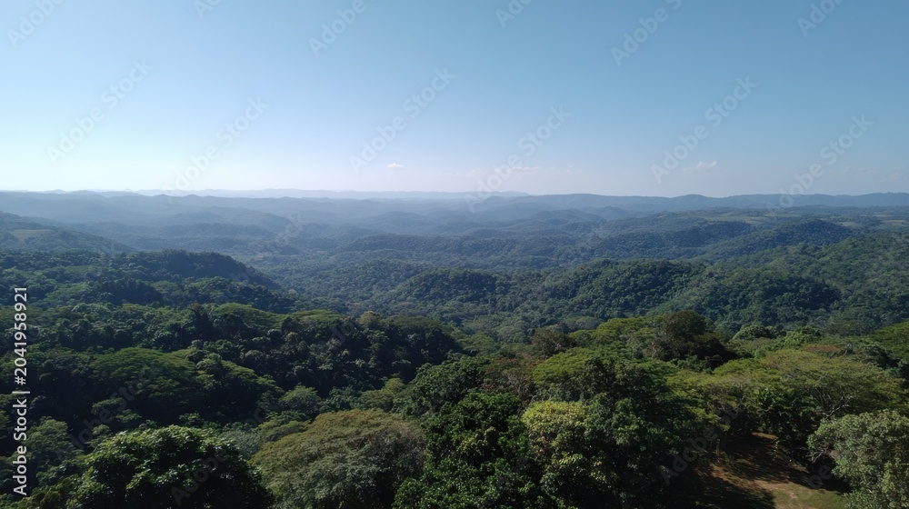 Fototapeta premium Lush Green Hills and Vast Blue Sky Over Serene Mountain Landscape in a Peaceful Natural Setting